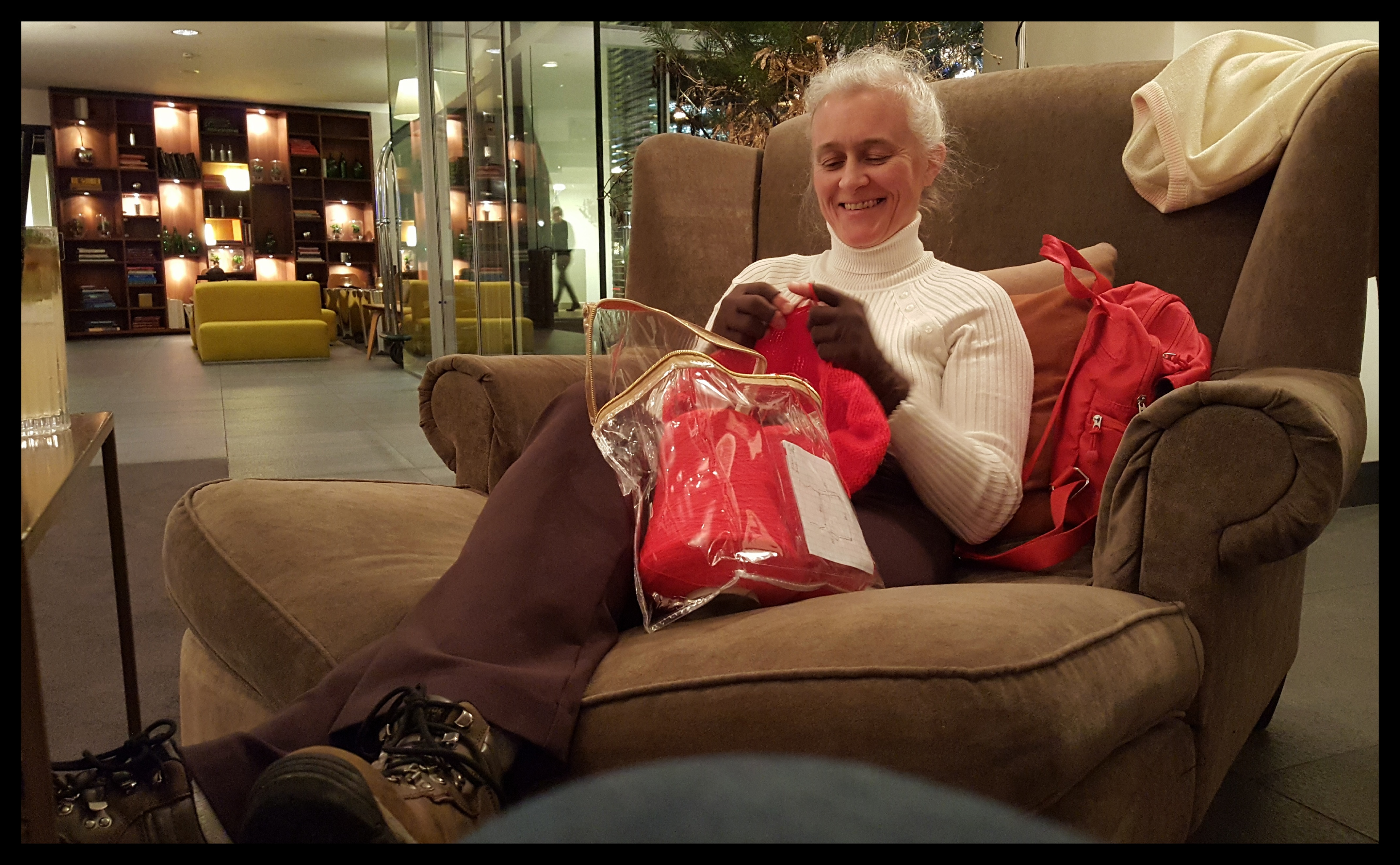 My brother's wife can knit anywhere. Here she is in a giant chair in their hotel lobby. Photo by Dragonfly Leathrum